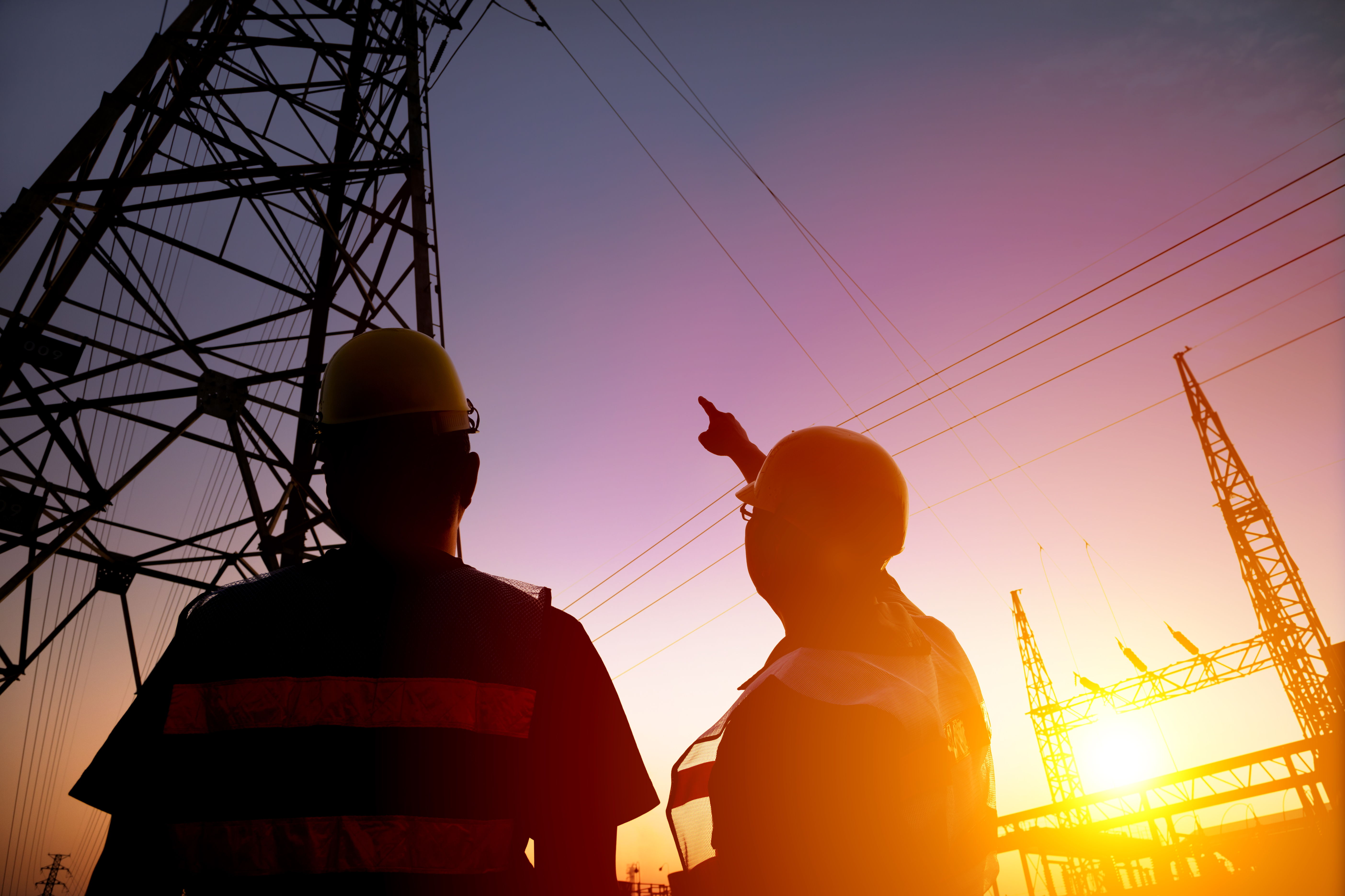 Workers watching electrical tower